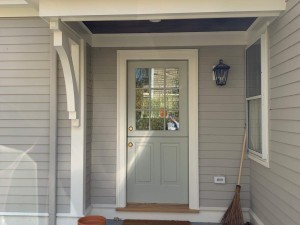 new siding and doorway with finish carpentry
