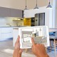 Person Holding Tablet with Drawings of Kitchen