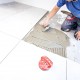 A contractor installing new kitchen bathroom tile