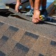 person laying down shingle