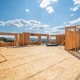 A,New,Construction,Home,Being,Framed,On,A,Hillside,With